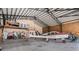 Spacious hangar featuring a small red and white airplane, complemented by the expansive ceiling and structural design at 1100 Mitchell Pl, Pahrump, NV 89060