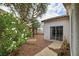 Backyard with a landscaped area, tree, and a view of the house at 114 Tamarack Dr, Henderson, NV 89002
