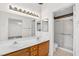 Bathroom featuring double sinks, a shower with glass doors, and a separate room for the toilet at 114 Tamarack Dr, Henderson, NV 89002