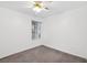 Cozy bedroom features a ceiling fan, neutral carpet, and a window for natural light at 114 Tamarack Dr, Henderson, NV 89002