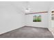 Spacious bedroom with neutral carpet, ceiling fan, and a window providing natural light at 114 Tamarack Dr, Henderson, NV 89002