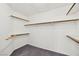 Walk-in closet featuring neutral carpet and custom wooden shelving at 114 Tamarack Dr, Henderson, NV 89002