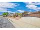 Wide exterior shot of a home featuring a xeriscaped front yard, desert landscaping, and a car port at 114 Tamarack Dr, Henderson, NV 89002