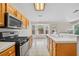 Kitchen with black appliances, tile counters and floors and views to the sunny back yard at 114 Tamarack Dr, Henderson, NV 89002