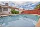 Swimming pool and equipment surrounded by a brick wall and lush green trees at 114 Tamarack Dr, Henderson, NV 89002