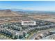 Serene aerial shot of a home community, showcasing modern residences and scenic surroundings with distant city views at 11695 Gentle Birdsong Ave, Las Vegas, NV 89138