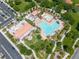 Stunning aerial view of community pool, clubhouse, and lush green spaces, perfect for relaxation and recreation at 11695 Gentle Birdsong Ave, Las Vegas, NV 89138