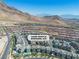 Beautiful aerial view of a modern home community, framed by majestic mountains and a vast, scenic landscape at 11695 Gentle Birdsong Ave, Las Vegas, NV 89138