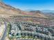 Overhead perspective of a stylish neighborhood set against a backdrop of towering mountains, capturing the essence of community living at 11695 Gentle Birdsong Ave, Las Vegas, NV 89138