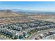 Expansive aerial view of a community, highlighting the modern architecture, organized street layout, and vast desert landscape at 11695 Gentle Birdsong Ave, Las Vegas, NV 89138