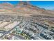 Picturesque aerial view of a new home community featuring modern architecture and well-planned streets against a mountain backdrop at 11695 Gentle Birdsong Ave, Las Vegas, NV 89138