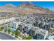 Expansive aerial shot featuring modern homes, mountainous backdrop, and a well-planned community layout at 11695 Gentle Birdsong Ave, Las Vegas, NV 89138