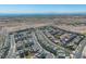 Dramatic aerial view of a home community showcasing modern living, set against a desert backdrop and distant city views at 11695 Gentle Birdsong Ave, Las Vegas, NV 89138