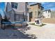Backyard featuring a modern trampoline and a cute playhouse on faux grass at 11695 Gentle Birdsong Ave, Las Vegas, NV 89138