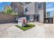 Wide backyard featuring a trampoline, playhouse on faux grass, and a patio at 11695 Gentle Birdsong Ave, Las Vegas, NV 89138
