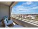 Relaxing balcony space with comfortable lounge chairs, offering views of the neighborhood at 11695 Gentle Birdsong Ave, Las Vegas, NV 89138