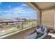 Inviting balcony with lounge chairs, showcasing views of the surrounding neighborhood and blue skies at 11695 Gentle Birdsong Ave, Las Vegas, NV 89138