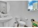 Powder room with sink and vanity adjacent to the toilet at 11695 Gentle Birdsong Ave, Las Vegas, NV 89138