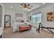 Elegant main bedroom with a tufted headboard bed, ceiling fan, and carpeted floor at 11695 Gentle Birdsong Ave, Las Vegas, NV 89138