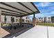 Community pergola featuring seating, a brick-paved area, and a concrete area for relaxation and enjoyment at 11695 Gentle Birdsong Ave, Las Vegas, NV 89138
