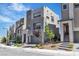 Modern townhome with neutral stucco, attached garage, and drought-tolerant landscaping at 11695 Gentle Birdsong Ave, Las Vegas, NV 89138