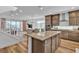 Open kitchen features a large island and flows into the living and dining areas at 11695 Gentle Birdsong Ave, Las Vegas, NV 89138