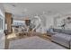 Open-concept living room with a dining area, staircase, and light wood flooring at 11695 Gentle Birdsong Ave, Las Vegas, NV 89138