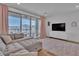 Stylish living room with a gray sectional sofa and sliding glass doors to the outside at 11695 Gentle Birdsong Ave, Las Vegas, NV 89138