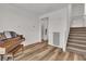 Open living room with staircase, and a hardwood floor at 11695 Gentle Birdsong Ave, Las Vegas, NV 89138