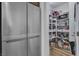 Walk-in pantry with metal shelving and generous storage space adjacent to a refrigerator at 11695 Gentle Birdsong Ave, Las Vegas, NV 89138