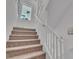 The carpeted staircase leads to the upper level of the home at 11695 Gentle Birdsong Ave, Las Vegas, NV 89138