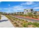A view of the street with modern homes and landscaped common areas at 11695 Gentle Birdsong Ave, Las Vegas, NV 89138