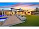 Stunning backyard oasis with a luxurious pool, sprawling lawn, and multiple outdoor living spaces for entertaining at 11906 Port Labelle Dr, Las Vegas, NV 89141