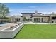 Expansive backyard features a sparkling pool, lush greenery, and ample space for outdoor activities and relaxation at 11906 Port Labelle Dr, Las Vegas, NV 89141