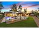 Spacious backyard featuring a modern pool, manicured lawn, and elegant patio areas for ultimate relaxation at 11906 Port Labelle Dr, Las Vegas, NV 89141