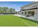 Covered patio with an outdoor kitchen, dining, and lush green yard at 11906 Port Labelle Dr, Las Vegas, NV 89141