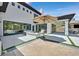 Expansive backyard patio with a fire pit, modern furniture, and large sliding doors for indoor-outdoor living at 11906 Port Labelle Dr, Las Vegas, NV 89141