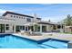 Luxurious backyard with a pool, lounge chairs, a covered patio, and impeccable landscaping for outdoor enjoyment at 11906 Port Labelle Dr, Las Vegas, NV 89141