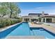 Beautiful backyard showcasing a pristine pool with a spa, lounge area, and manicured landscaping for serene outdoor living at 11906 Port Labelle Dr, Las Vegas, NV 89141