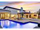 A luxurious backyard featuring a sparkling pool, multiple patios, and lush landscaping, perfect for entertaining at 11906 Port Labelle Dr, Las Vegas, NV 89141