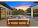 Inviting backyard with pool, fire pit, comfortable seating, and serene landscaping at twilight at 11906 Port Labelle Dr, Las Vegas, NV 89141