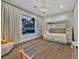 Cozy bedroom with a bunk bed, large window, and hardwood floors at 11906 Port Labelle Dr, Las Vegas, NV 89141