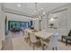 Bright dining area with modern lighting fixture and seamlessly connects to the living room and outdoor patio at 11906 Port Labelle Dr, Las Vegas, NV 89141