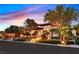 Spacious home with mature landscaping, illuminated steps, and a stucco exterior with a tile roof at dusk at 11906 Port Labelle Dr, Las Vegas, NV 89141
