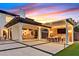 Beautiful home features a patio, outdoor kitchen, living room, and manicured landscaping at 11906 Port Labelle Dr, Las Vegas, NV 89141