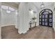 Welcoming foyer boasts modern lighting, stylish console, and an elegant arched doorway enhancing its appeal at 11906 Port Labelle Dr, Las Vegas, NV 89141