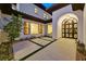 Landscaped driveway and decorative iron front door of a stucco home with a tile roof at twilight at 11906 Port Labelle Dr, Las Vegas, NV 89141