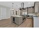 Well-equipped kitchen with a large island including bar fridge and gas range, custom cabinetry, and modern stainless appliances at 11906 Port Labelle Dr, Las Vegas, NV 89141