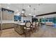 Bright, modern kitchen features a large island, stainless steel appliances, pendant lighting, and bar stool seating at 11906 Port Labelle Dr, Las Vegas, NV 89141
