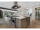 Open-concept kitchen with a large island, stainless steel appliances, and modern lighting at 11906 Port Labelle Dr, Las Vegas, NV 89141